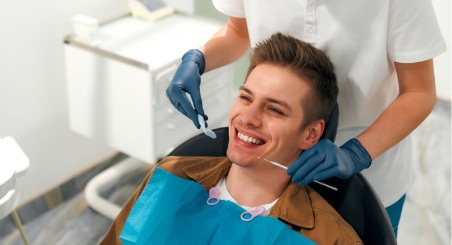 The Male Patient Happily Smiling After His Dental Treatment