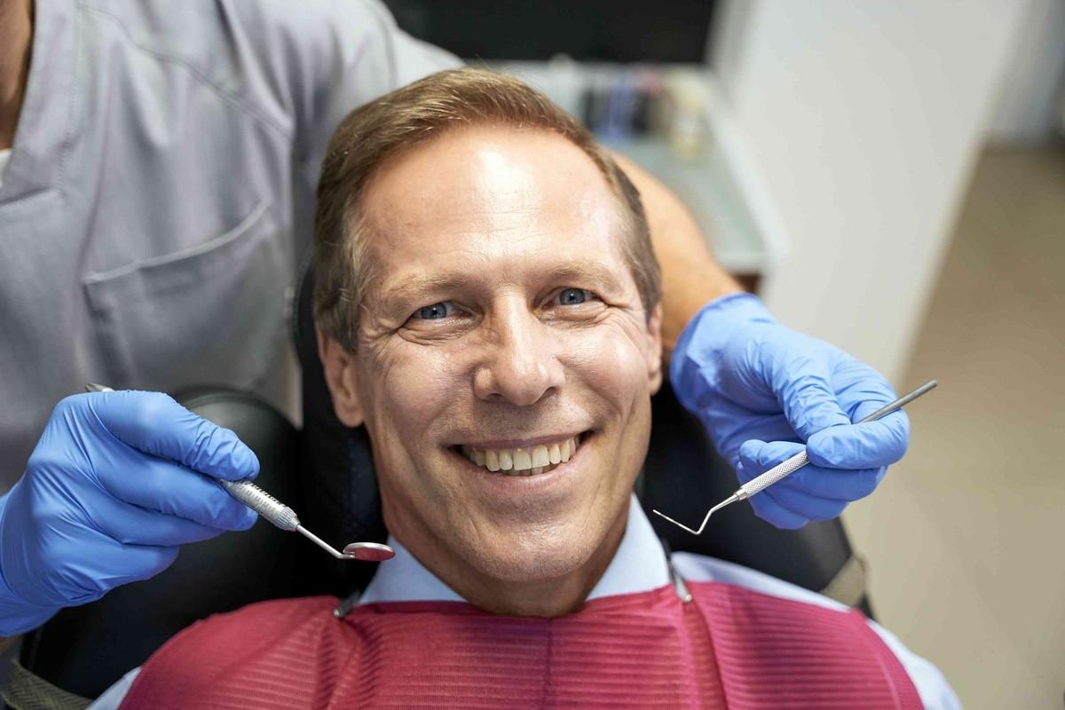 Patient receiving a complete dental checkup with a dentist during a routine dental examination