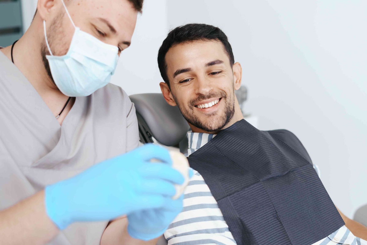 Patient discussing front teeth improvement with a dentist during a veneer consultation