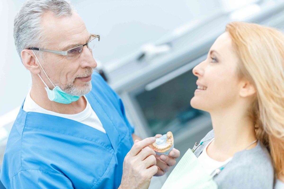 Dentist discussing dental veneers for front teeth with a patient